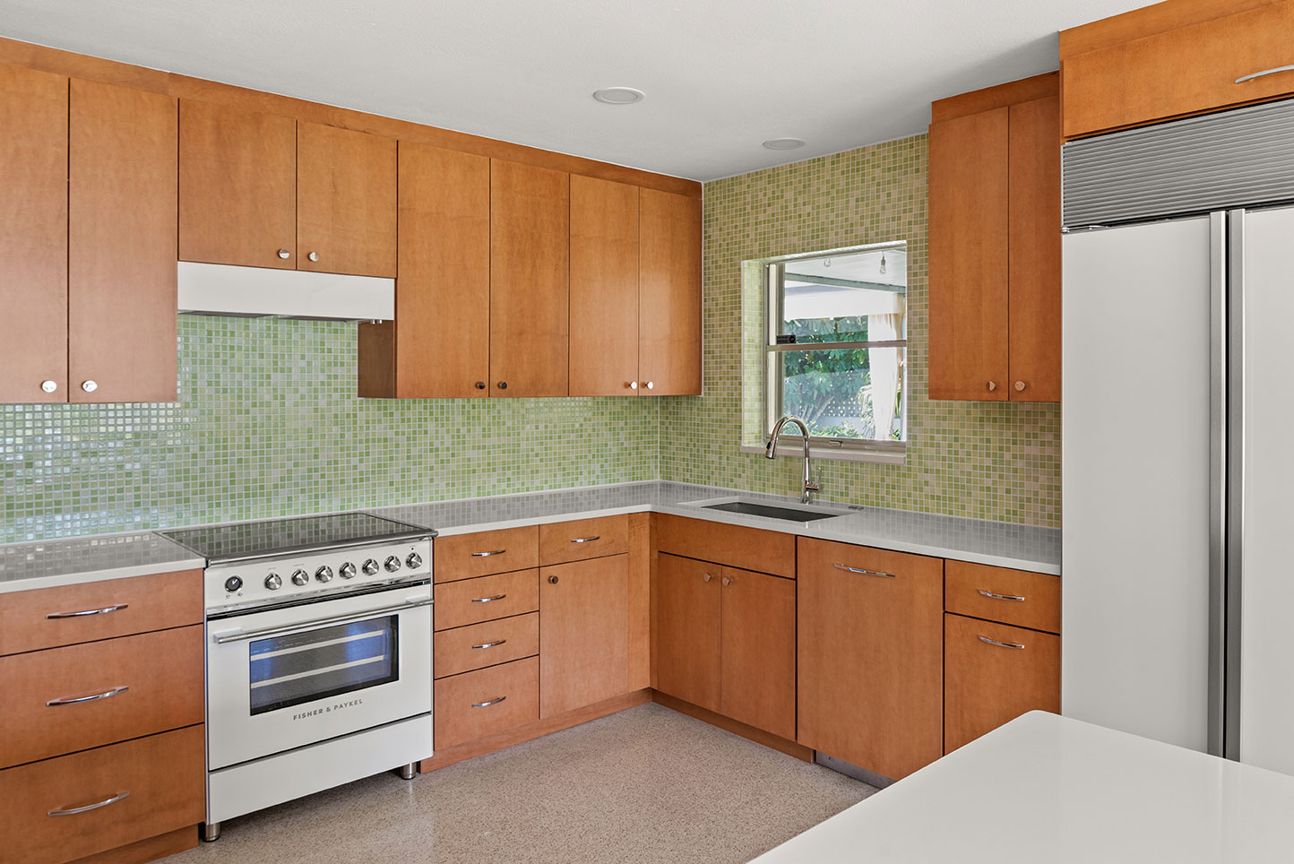 modern kitchen remodel featuring green backsplash and warm wood cabinets in brevard county, fl 