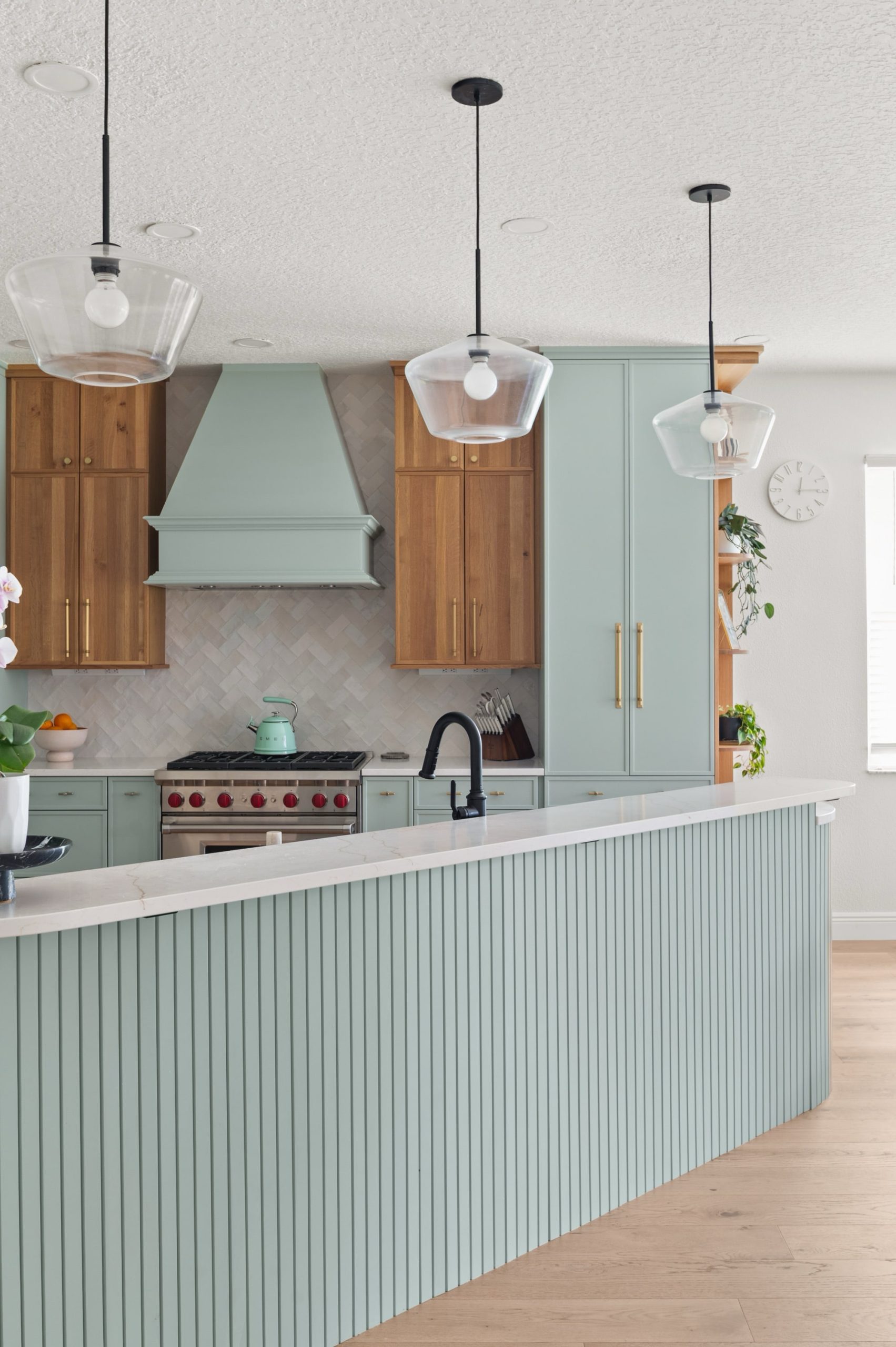 Natural wood and soft blue-green hood in kitchen remodel Windermere, FL