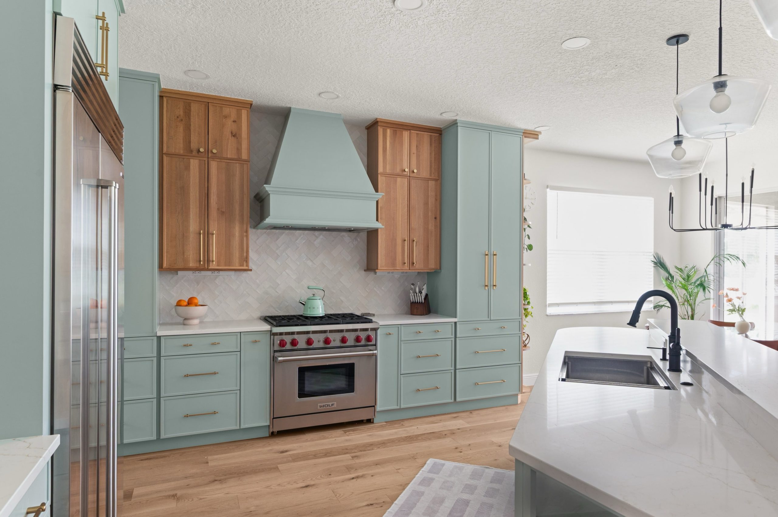Amelia Pond Drive  kitchen remodel statement range hood, and a subtle herringbone backsplash