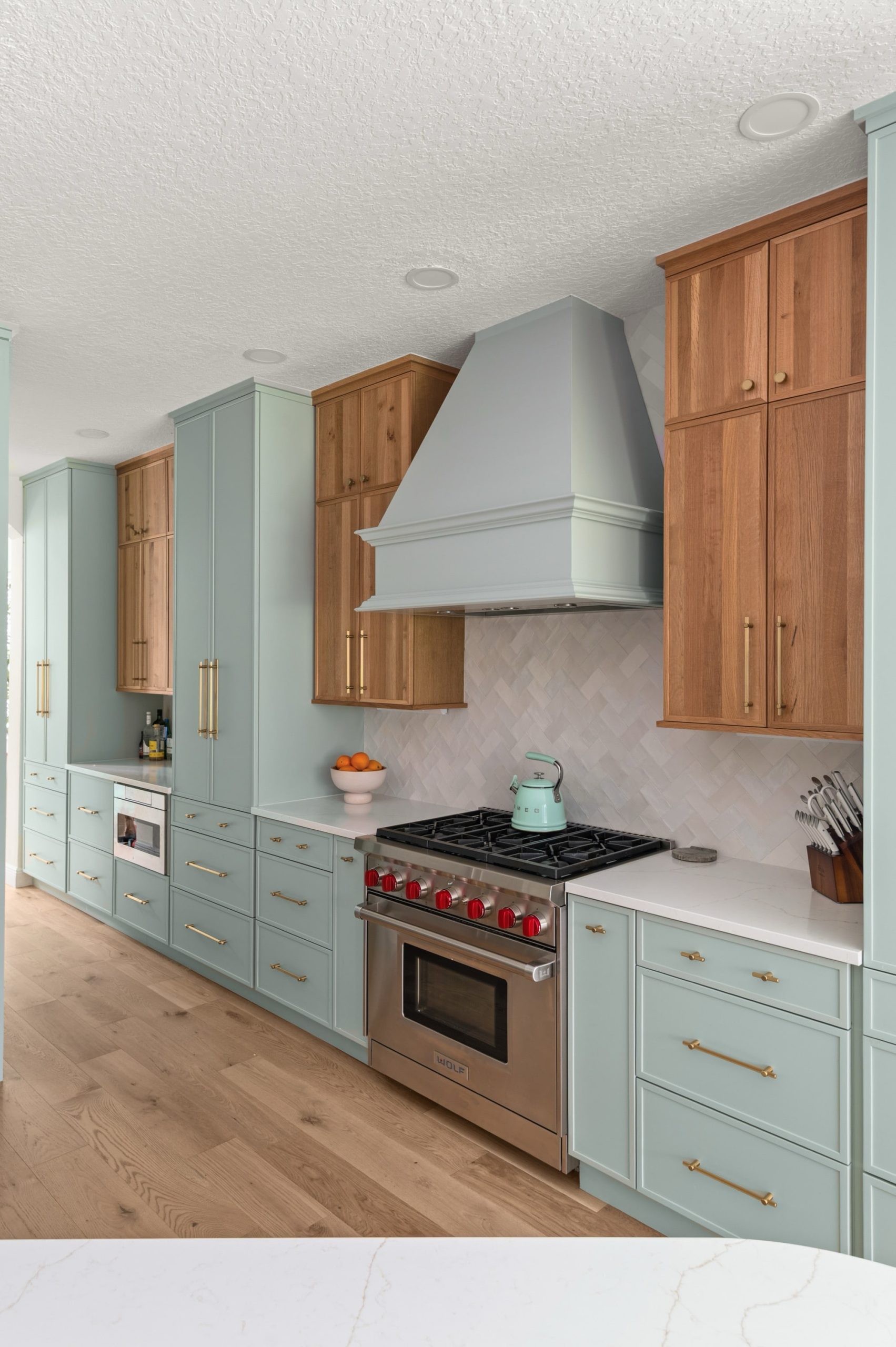Amelia Pond Drive soft blue-green and natural wood kitchen cabinets